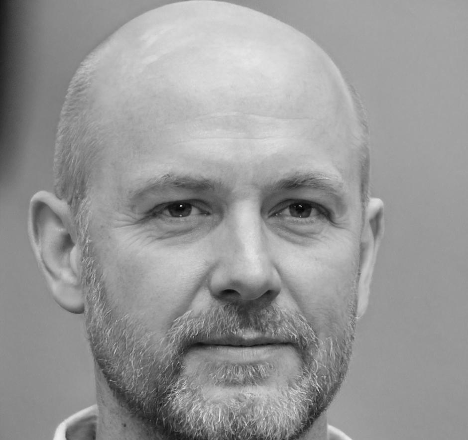 Professional headshot of financial education specialist and business mentor
