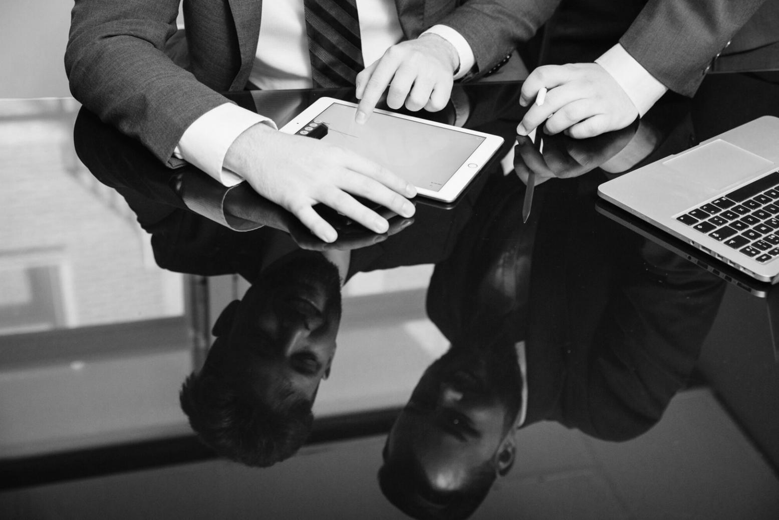 Business professionals collaborating on financial planning documents and strategic analysis